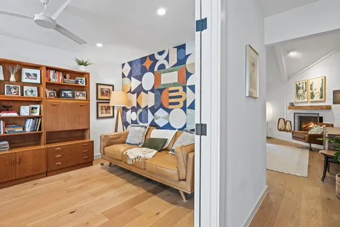 a bedroom with furniture and a book shelf