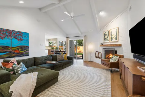 a living room with fireplace furniture and a flat screen tv
