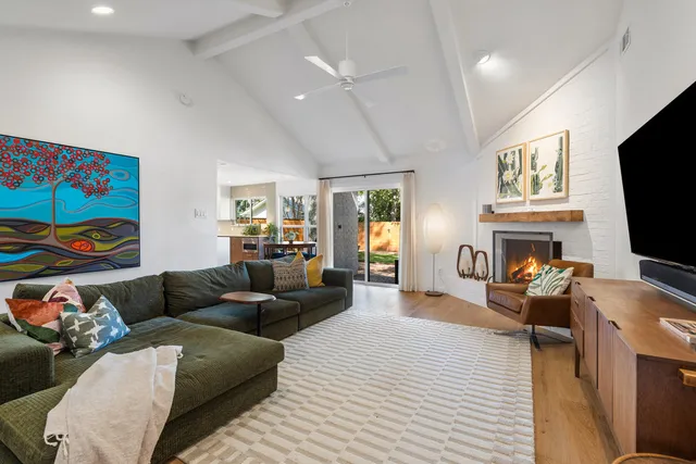 a kitchen with kitchen island granite countertop a sink and a refrigerator