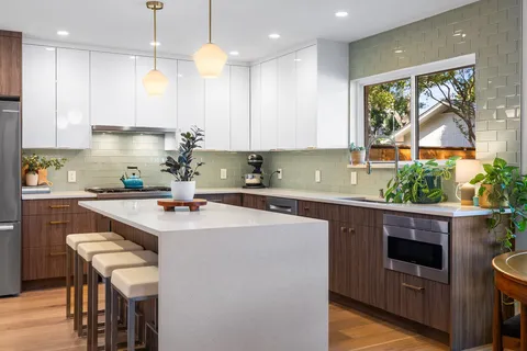 a kitchen with a sink a window and stainless steel appliances
