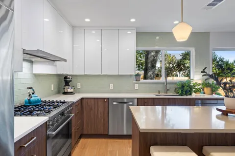 a kitchen with a table and chairs in it