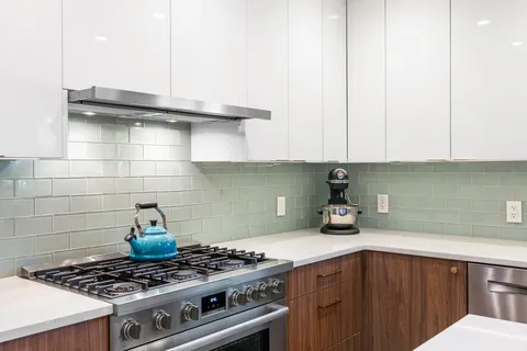 a kitchen with a stove and cabinets