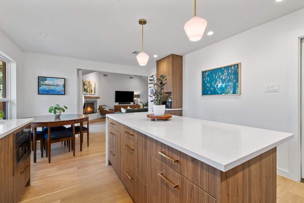 4618 Trail Crest Circle Austin, TX 78735 - Photo 22 of 40 a kitchen with a table chairs and white cabinets