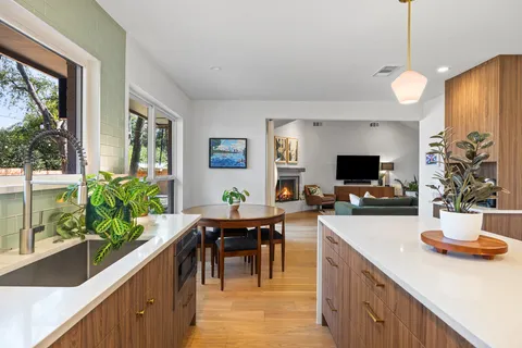 a room with furniture a flat screen tv and a large window