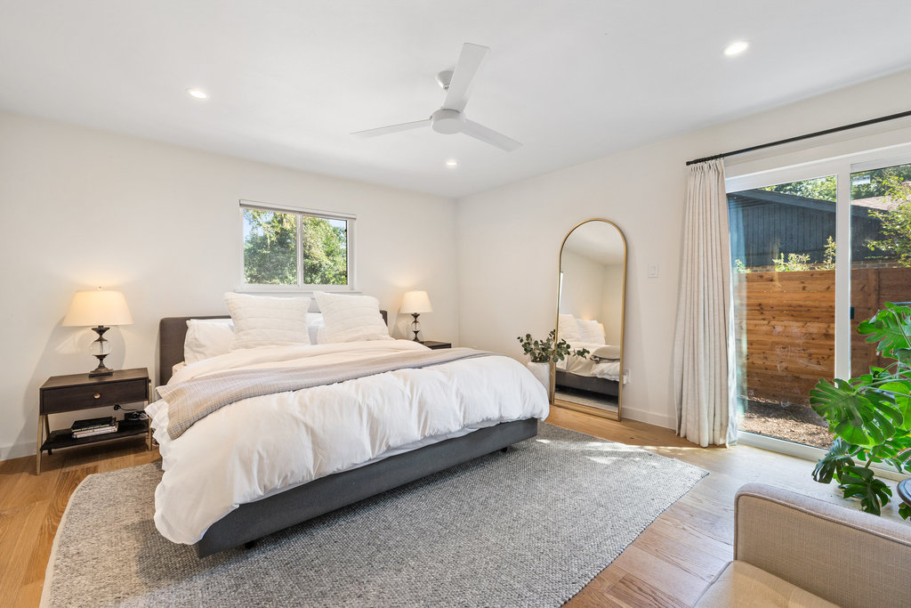 4618 Trail Crest Circle Austin, TX 78735 - Photo 24 of 40 a spacious bedroom with a bed a couch and potted plant