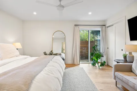 a bedroom with furniture and a window