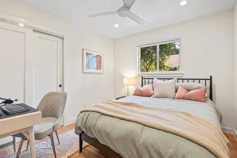 a bedroom with a bed and a chair