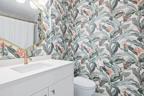 a bathroom with a sink and mirror with toilet