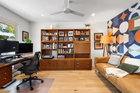 a view of a livingroom with workspace and a couch