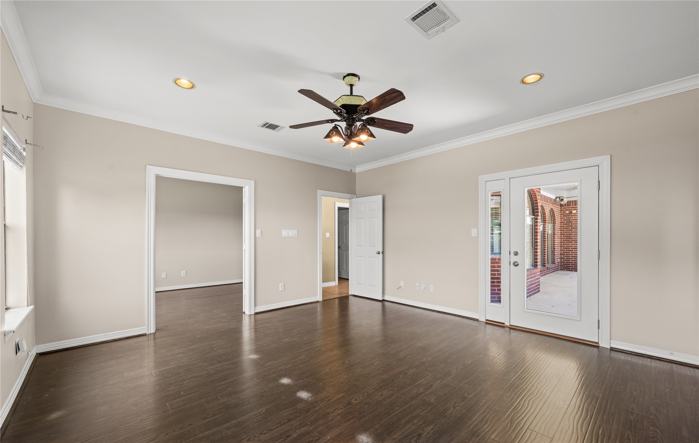 20240 Cypress Rosehill Road Tomball, TX 77377 - Photo 25 of 26 an empty room with wooden floor and a ceiling fan