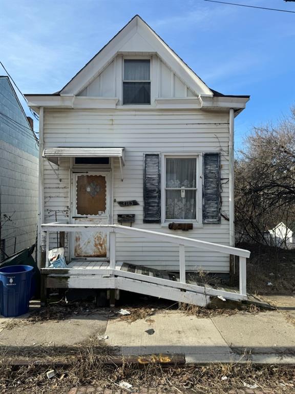 a view of a house with a yard and sitting area