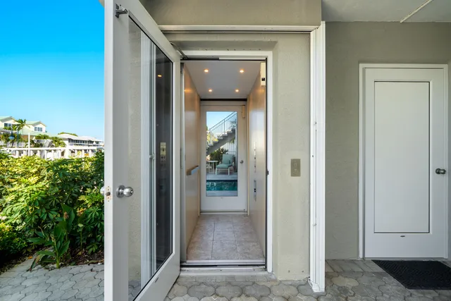 a view of a hallway with a glass door and stairs