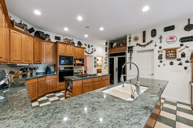 a bathroom with a granite countertop sink toilet a mirror and shower