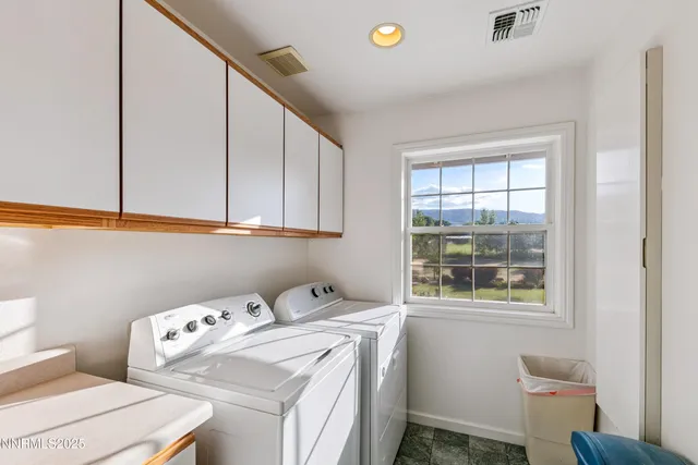 a living room with furniture flat screen tv and a large window