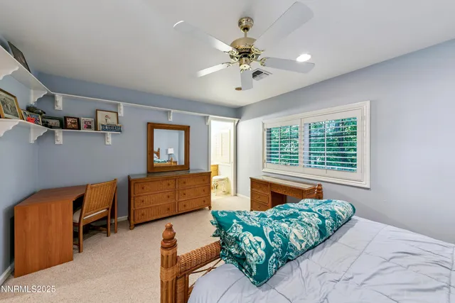 a spacious bathroom with a granite countertop sink toilet a large mirror a shower and bathtub