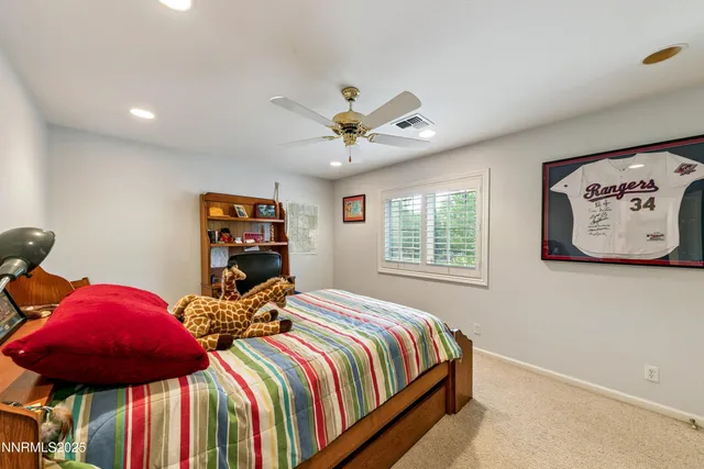 a bed room with a bed and a large window