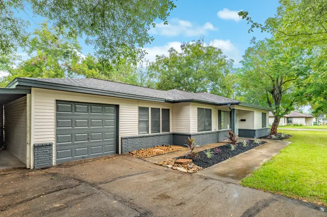 a front view of house with yard outdoor seating and barbeque oven