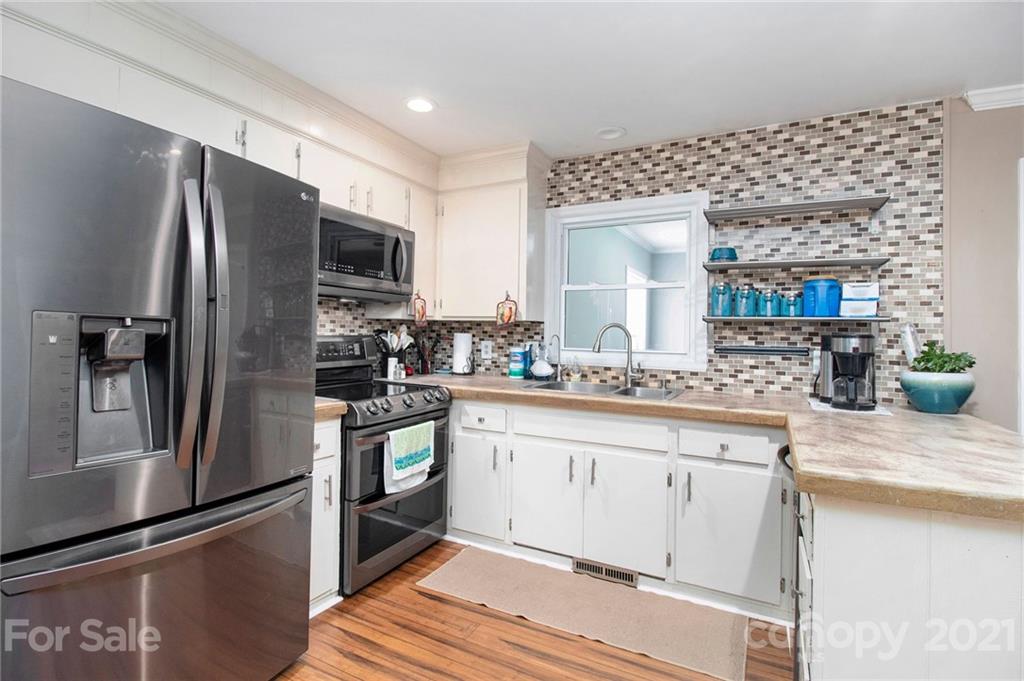 5702 Griffith Road Monroe, NC 28112 - Photo 11 of 35 a kitchen with stainless steel appliances a refrigerator sink and microwave