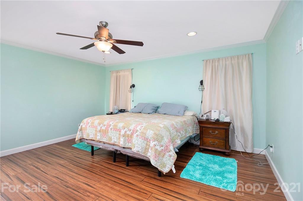 5702 Griffith Road Monroe, NC 28112 - Photo 14 of 35 a bedroom with a bed and wooden floor