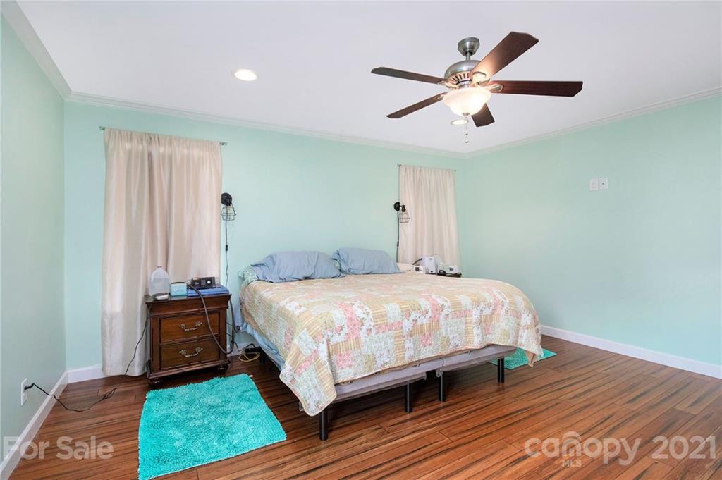 5702 Griffith Road Monroe, NC 28112 - Photo 16 of 35 a bedroom with a bed and a ceiling fan