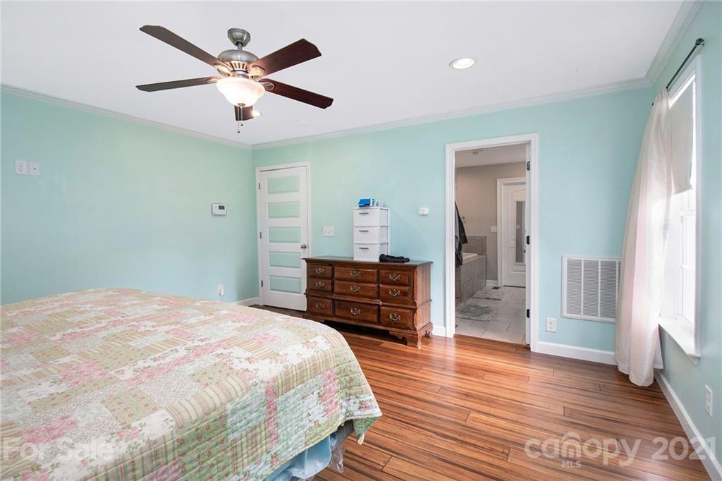 5702 Griffith Road Monroe, NC 28112 - Photo 17 of 35 a bedroom with a bed and wooden floor