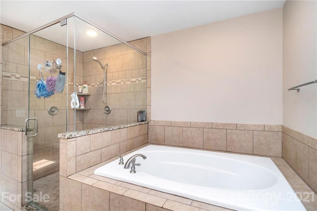 5702 Griffith Road Monroe, NC 28112 - Photo 19 of 35 a bathroom with a bathtub and shower