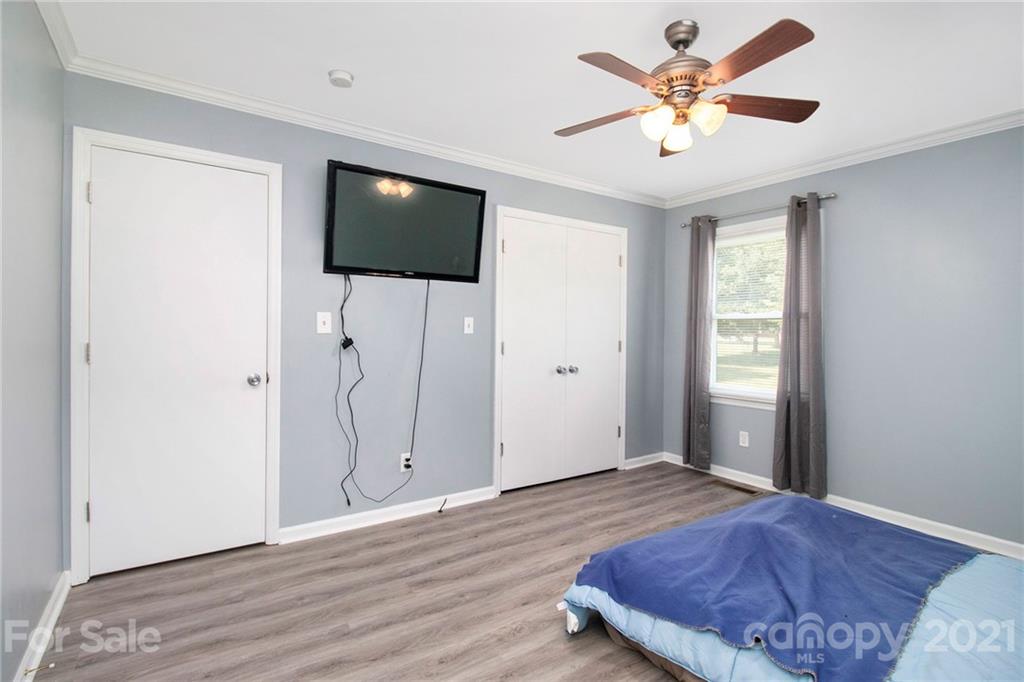 5702 Griffith Road Monroe, NC 28112 - Photo 21 of 35 a bedroom with a bed and a flat screen tv