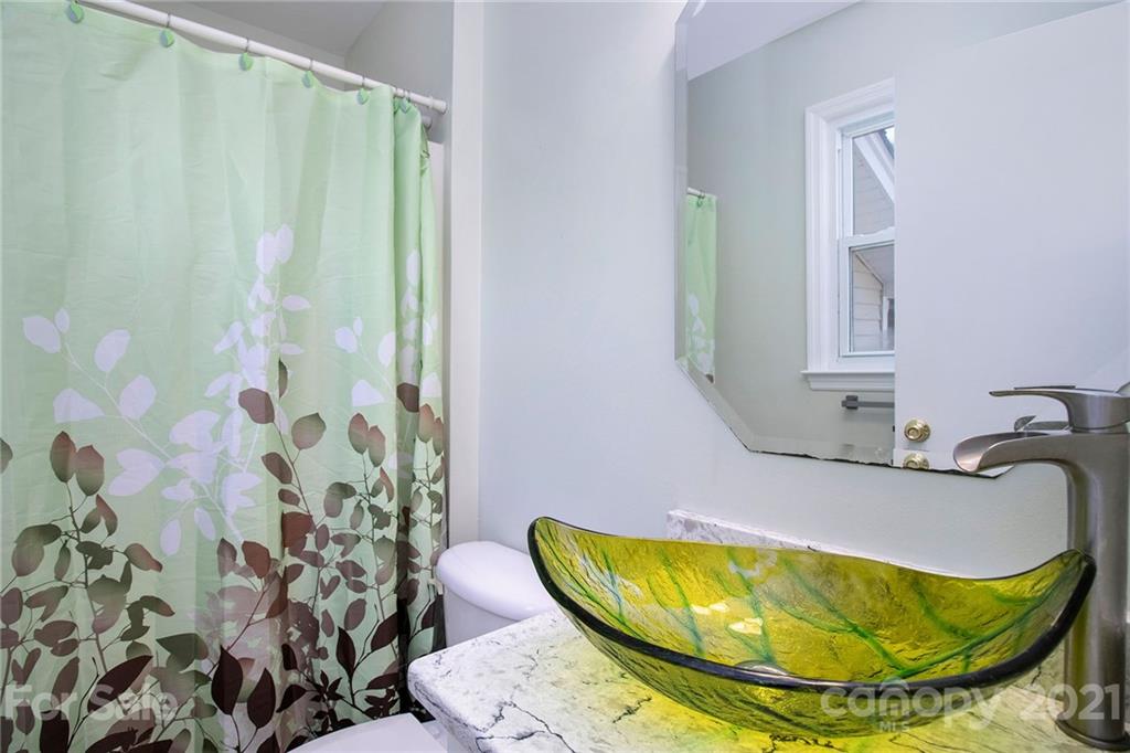 5702 Griffith Road Monroe, NC 28112 - Photo 23 of 35 a bathroom with a sink and mirror