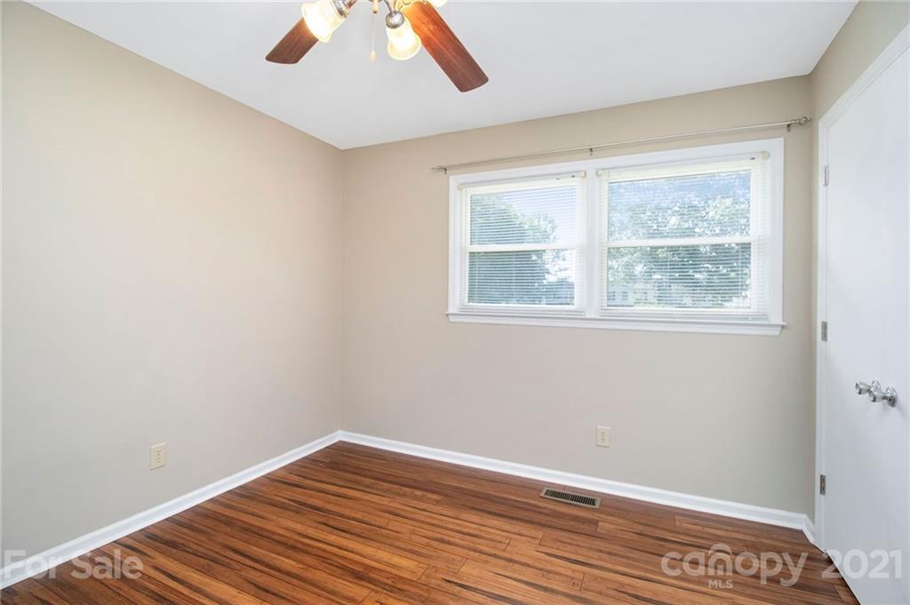 5702 Griffith Road Monroe, NC 28112 - Photo 26 of 35 a view of an empty room with wooden floor and a window