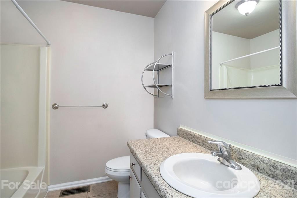 5702 Griffith Road Monroe, NC 28112 - Photo 28 of 35 a bathroom with a sink a toilet and mirror