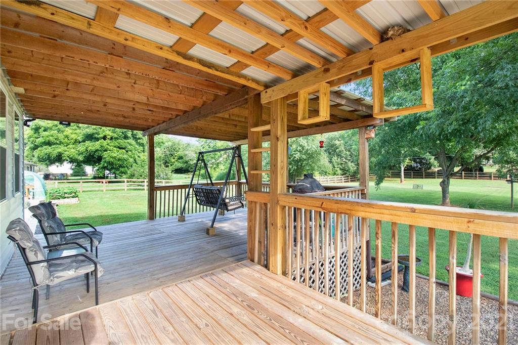 5702 Griffith Road Monroe, NC 28112 - Photo 29 of 35 a view of a patio with a table chairs and a backyard