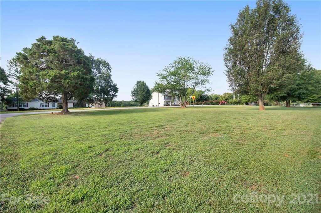 5702 Griffith Road Monroe, NC 28112 - Photo 35 of 35 a view of a green field with trees in the background