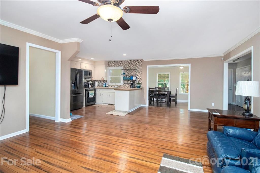 5702 Griffith Road Monroe, NC 28112 - Photo 7 of 35 a living room with furniture wooden floor and a flat screen tv