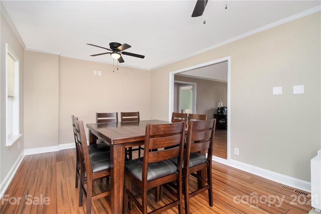 5702 Griffith Road Monroe, NC 28112 - Photo 8 of 35 a view of a dining room with furniture and wooden floor