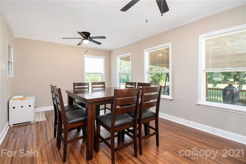 5702 Griffith Road Monroe, NC 28112 - Photo 9 of 35 a view of a dining room with furniture window and wooden floor