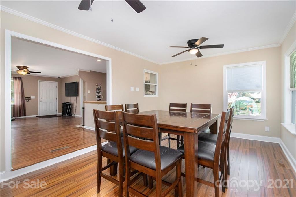 5702 Griffith Road Monroe, NC 28112 - Photo 10 of 35 a view of a dining room with furniture and wooden floor