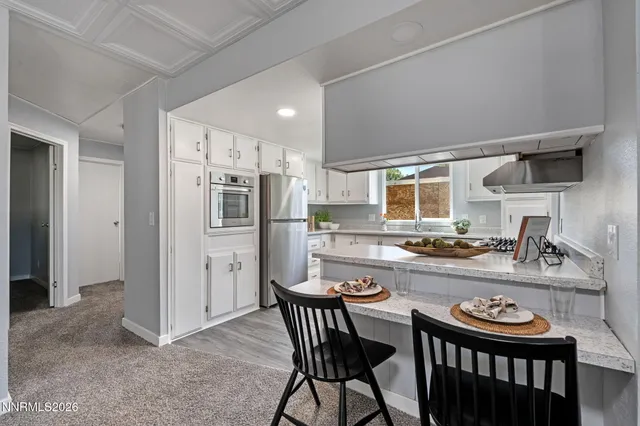a kitchen with refrigerator and stove