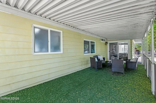 a backyard of a house with outdoor seating