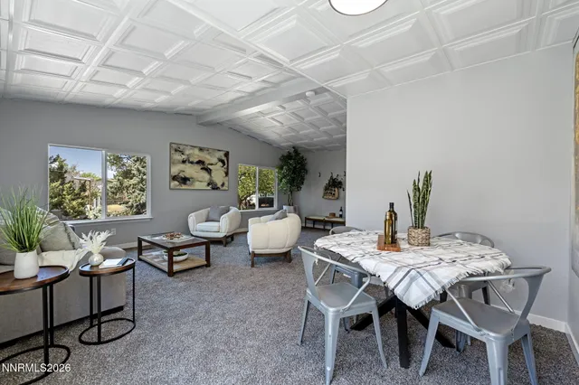 a dining room with furniture and window