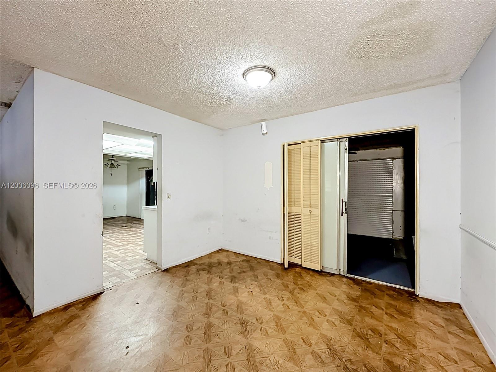 750 North Douglas Road Pembroke Pines, FL 33024 - Photo 2 of 6 an empty room with wooden floor and a bathroom