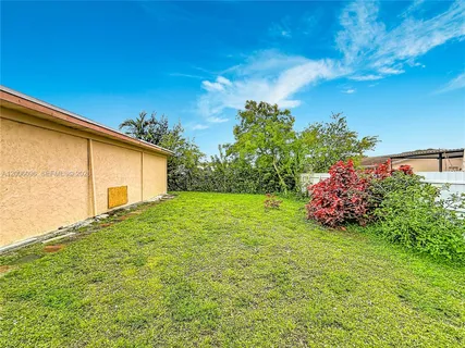 a view of a backyard with potted plants