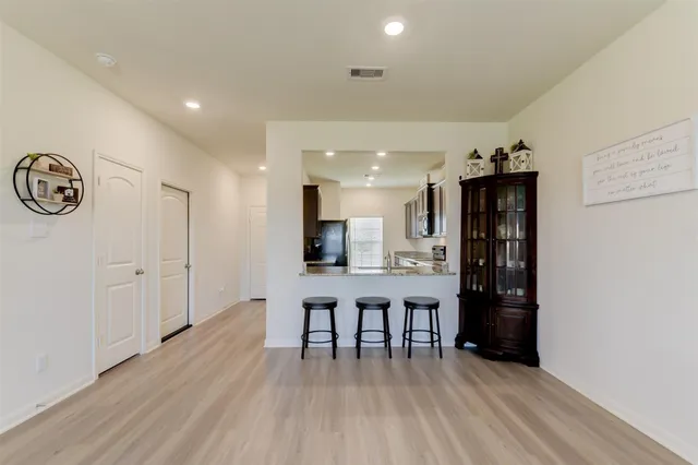 a view of a kitchen with cabinets and wooden floor