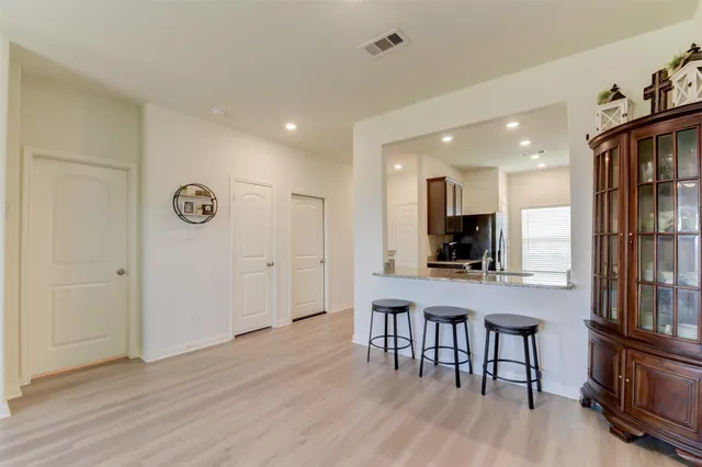 a view of kitchen with sink and wooden floor