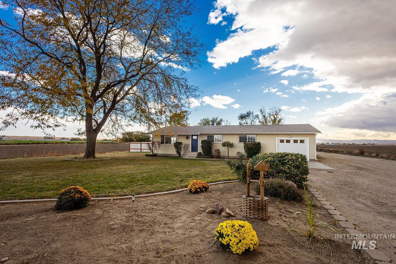 29339 Dixie Road Parma, ID 83660 - Photo 1 of 1 Ranch-style house with a front yard and a garage
