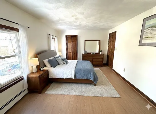 a bedroom with a bed couch and window