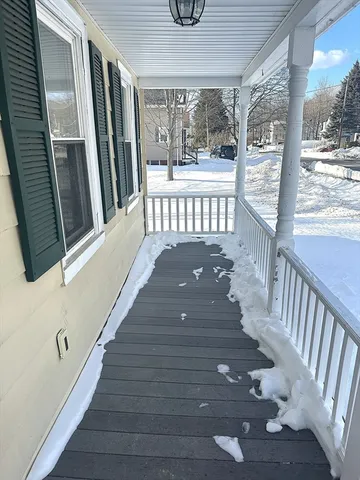 a view of a porch with wooden floor and fence