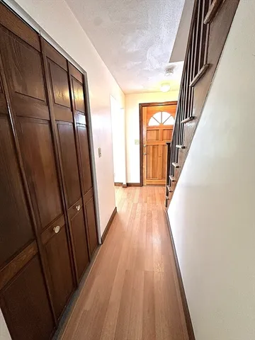 a view of staircase with wooden floor and railing