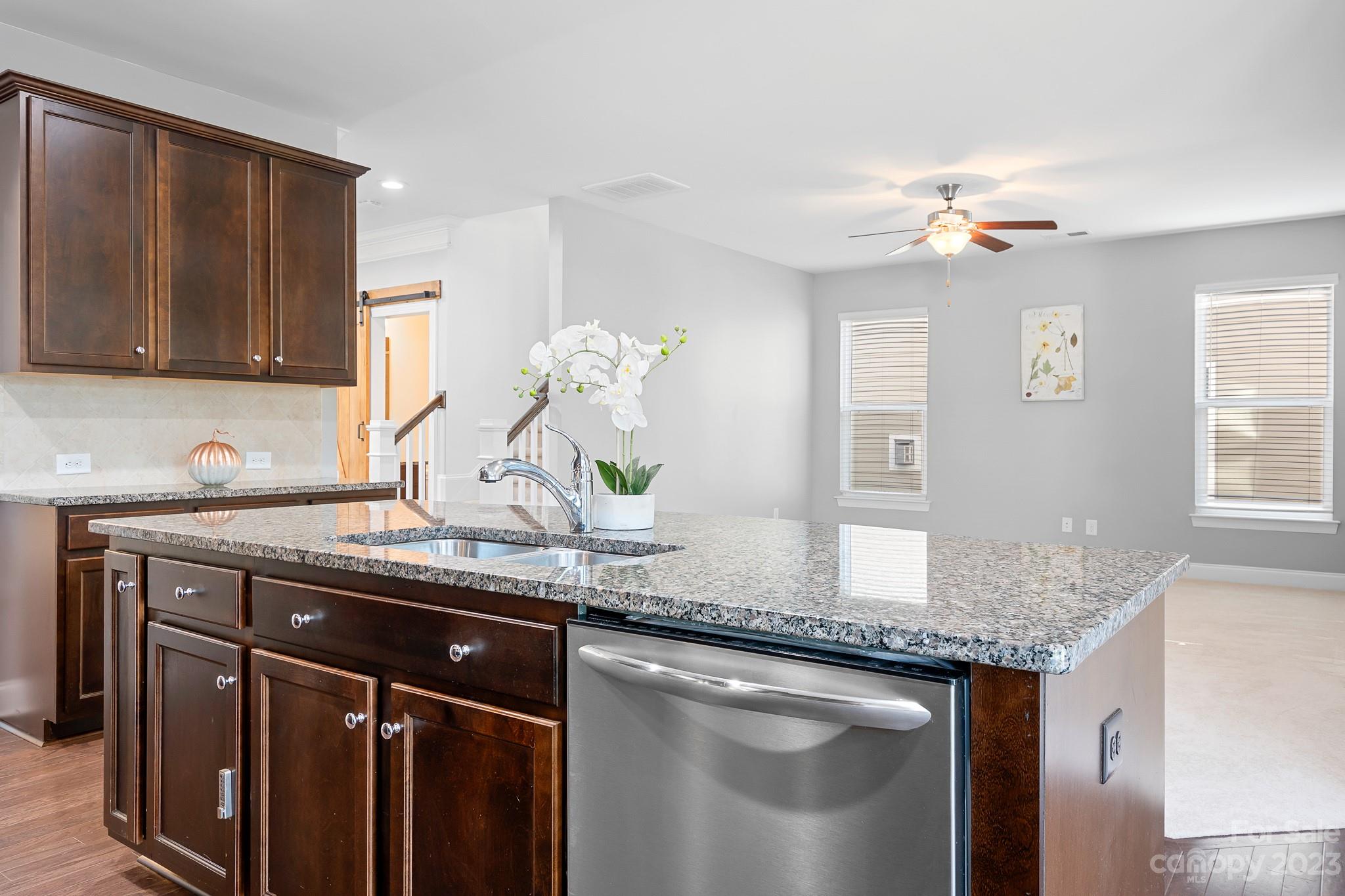 3329 Lucy Drive Monroe, NC 28110 - Photo 13 of 28 a kitchen with stainless steel appliances granite countertop a sink dishwasher and cabinets with wooden floor