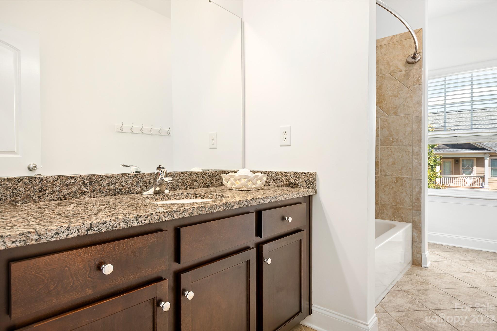 3329 Lucy Drive Monroe, NC 28110 - Photo 16 of 28 a bathroom with a granite countertop sink and a mirror