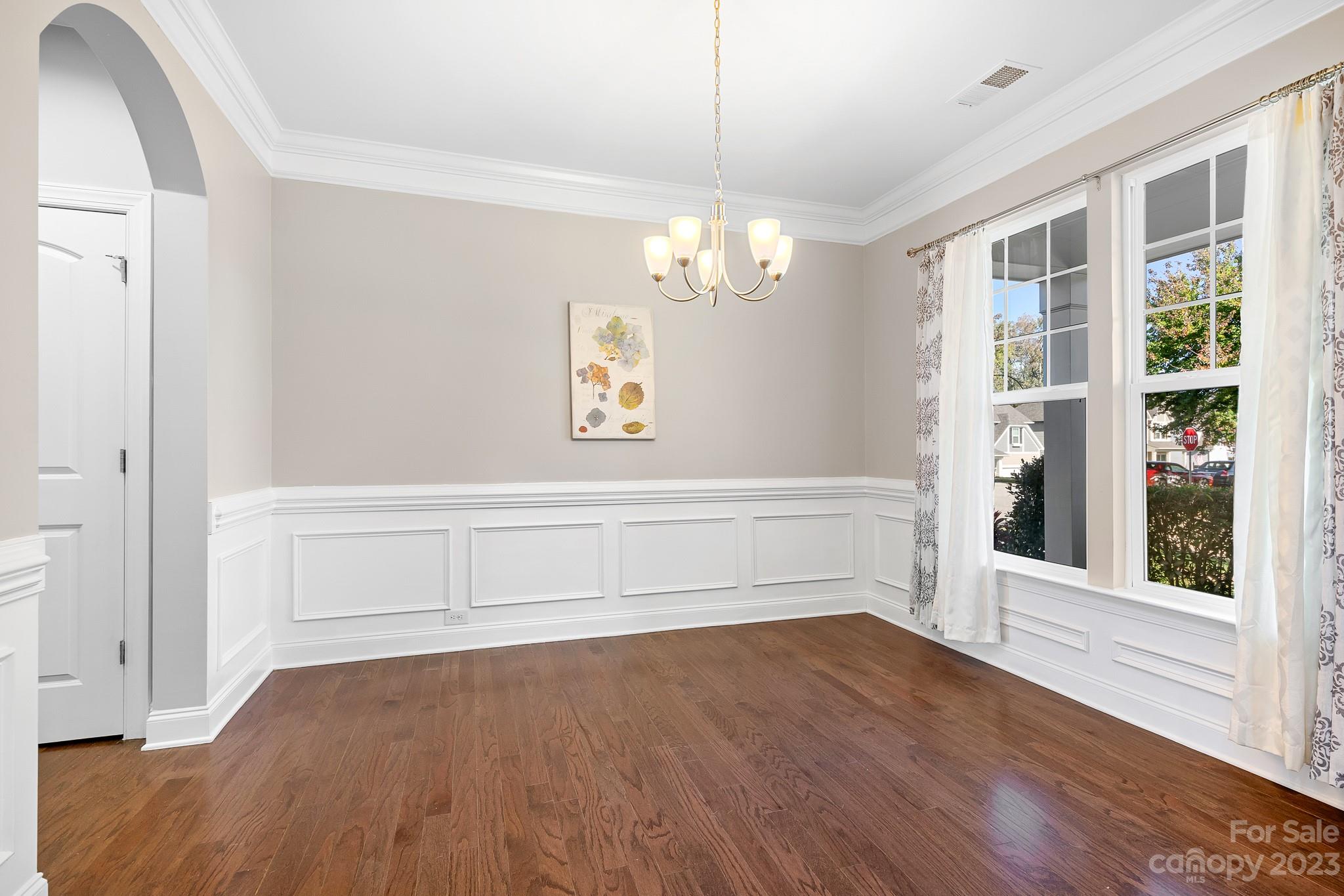 3329 Lucy Drive Monroe, NC 28110 - Photo 7 of 28 a view of an empty room with wooden floor and a window